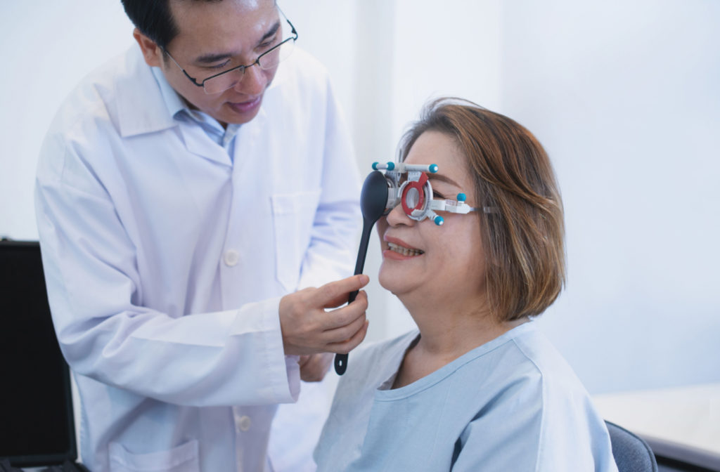 A woman undergoing a refraction test to determine her eyeglass prescription.