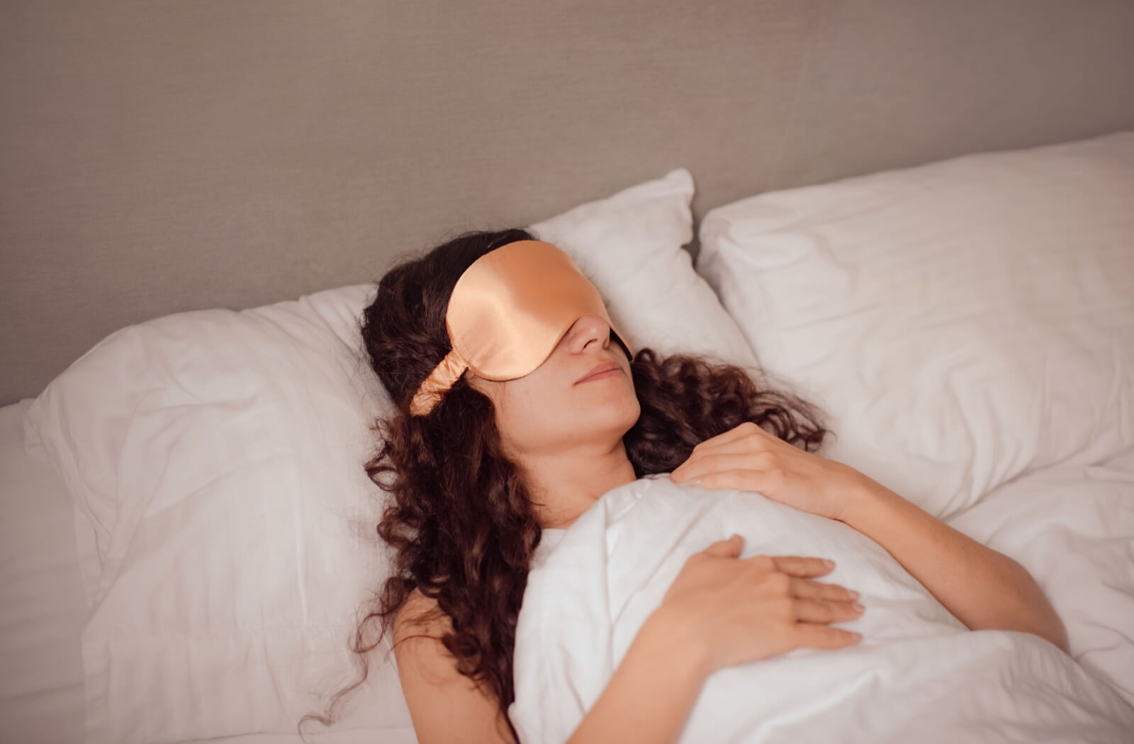 Young Woman Sleeping with Dry Eye Mask, Relaxing Under Cozy Blanket in Comfortable Bed at Home