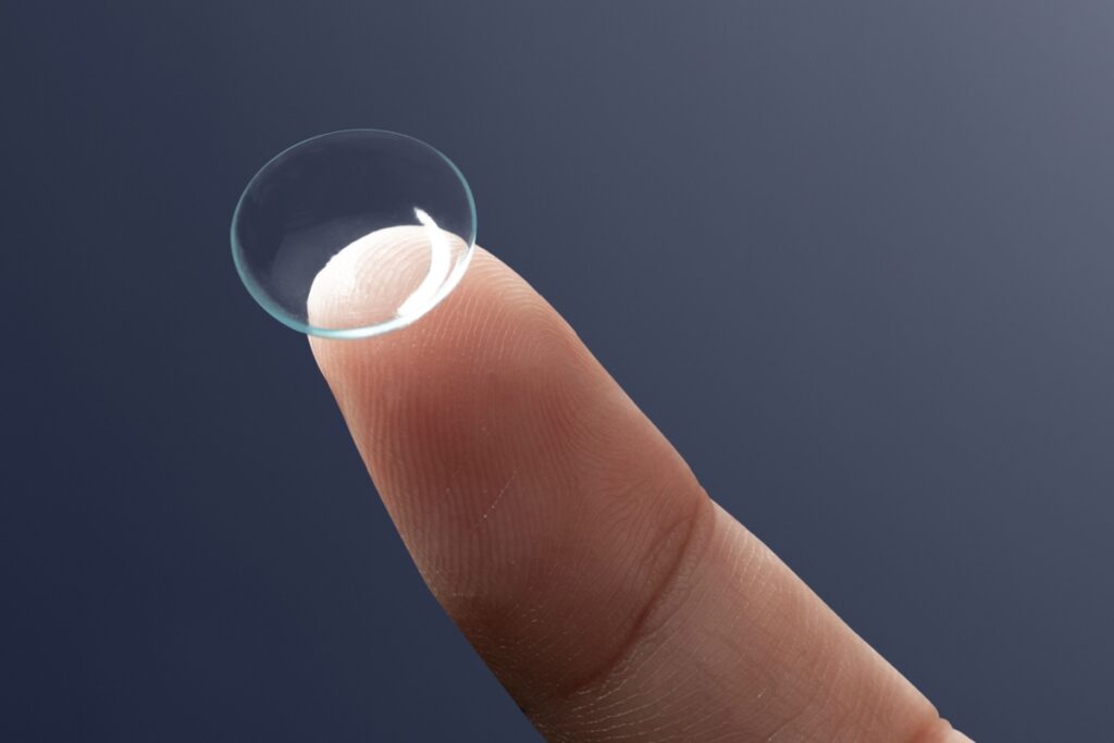 A contact lens on the tip of a finger