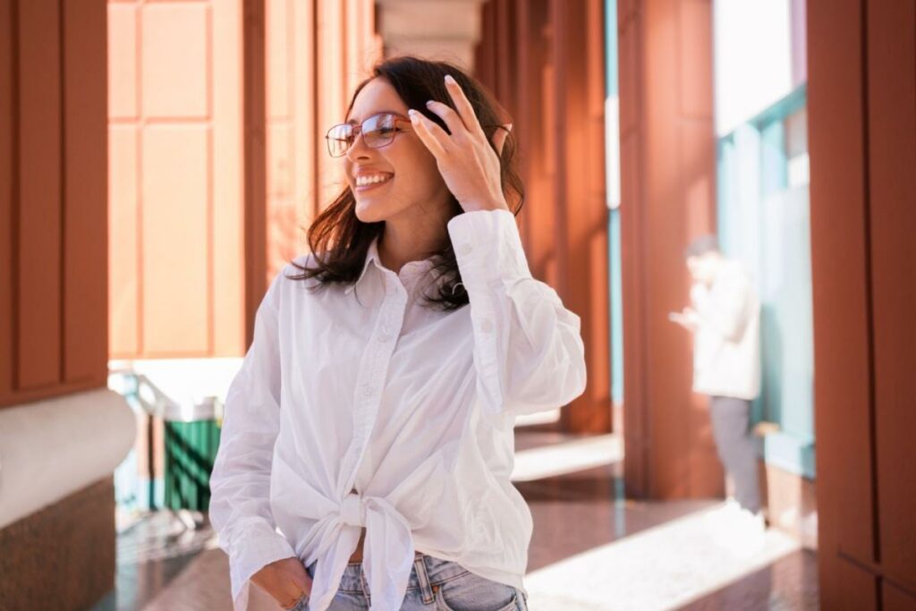 a person wearing trendy glasses for 2026 and smiling